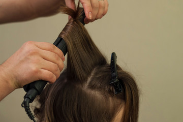Fototapeta premium Hairdresser working at the beauty studio salon, making hair style.