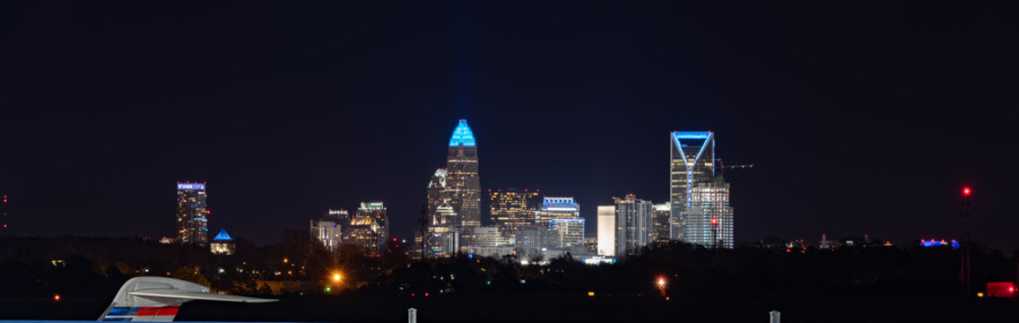 View of uptown downtown Charlotte, North Carolina skyline at night as seen from the CLT Airport