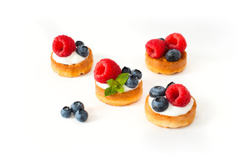 Belgian waffles with blueberry, raspberries and fresh mint on white background