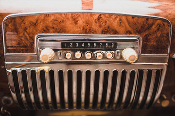 Retro styled image of an old car radio inside  classic car