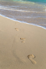 Footprints on a tropical white sand beach