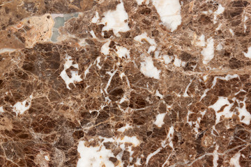 Granite texture. Light coloured base with brown and gray spots. Used as a background.