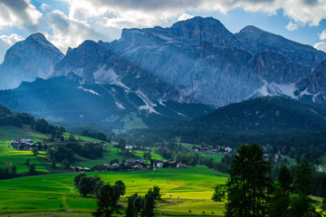 Scenic landscape panoramic view of Cortina D´Ampezzo and Tofana mountains, highest peaks in Dolomites, Italy. Popular tourist destination/attraction for active family holiday. Summer warm colours