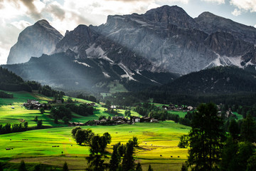 Scenic landscape panoramic view of Cortina D´Ampezzo and Tofana mountains, highest peaks in Dolomites, Italy. Popular tourist destination/attraction for active family holiday. Summer warm colours