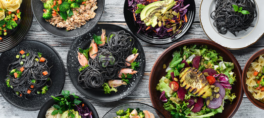 Food Background. Pasta, rice, risotto, salad. On a white wooden background. Free copy space.