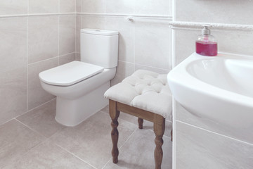 True real bathroom with toilet and sink with towels and purple soaps