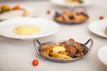 Potatoes with meat and mushrooms in the iron plate