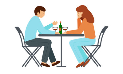 Man and woman sitting at a table. Guy and girl sitting opposite each other, on the table is a bottle of wine, glasses