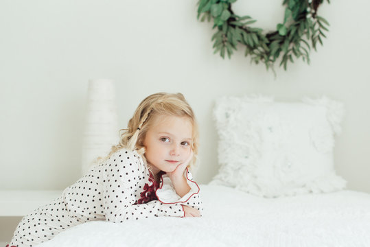 Young Girl Leaning On A Bed