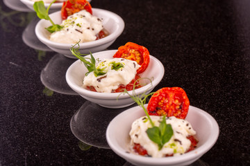Mousse from cheese mozzarella with dried tomatoes and greens