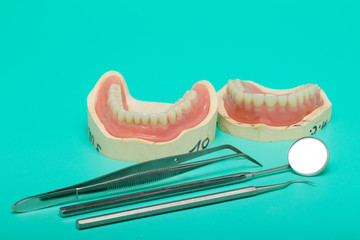 Dentures model with medical instruments