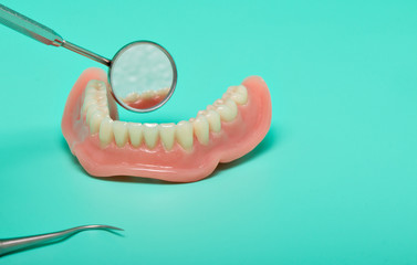 Dentures model with medical instruments