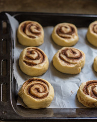 Obraz na płótnie Canvas cinnamon buns - Cinnabon cooking process raw dough. (food background). copy space