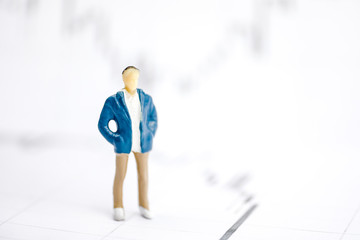 The concept of a young businessman. Human model on the background of graphs.