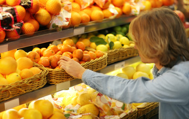 Young man buying fruits at the market