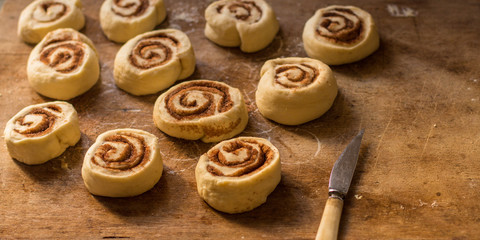 cinnamon buns - Cinnabon cooking process raw dough. (food background). copy space