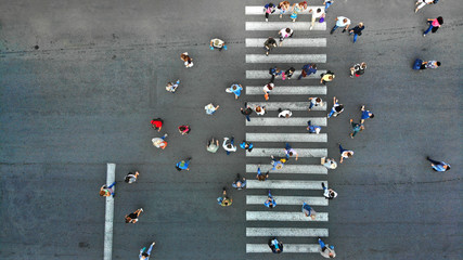 Aerial. Pedestrian crossing crosswalk top view. People crowd view above.