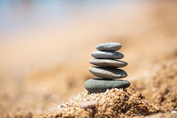 Fototapeta na wymiar Balance of stones on the beach, sunny day