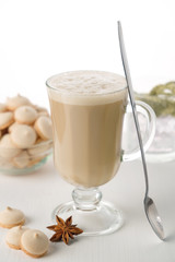 A glass of hot latte coffee with sweet cookies. Symbolic image.