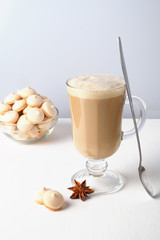 A glass of hot latte coffee with sweet cookies. Symbolic image.