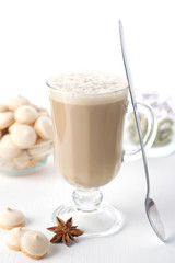 A glass of hot latte coffee with sweet cookies. Symbolic image.