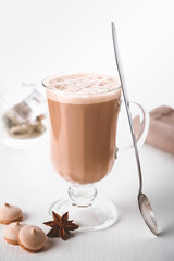 A glass of hot latte coffee with sweet cookies. Symbolic image.