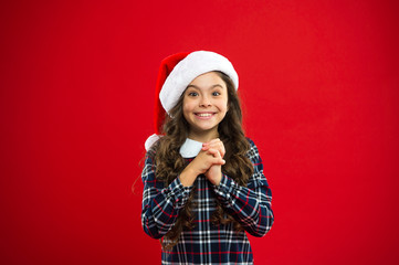 Best wishes. Little girl child in santa red hat. Christmas shopping. Happy winter holidays. Small girl. Present for Xmas. Childhood. New year party. Santa claus kid. Unexpected surprise