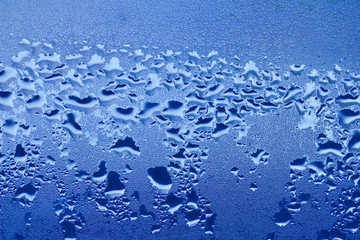 Macro abstract background design of window condensation in blue hues