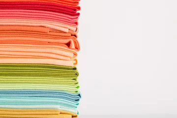 Rolgordijnen Fabric, pile of colorful cotton fabric isolated on white background, copy space © AnnJane