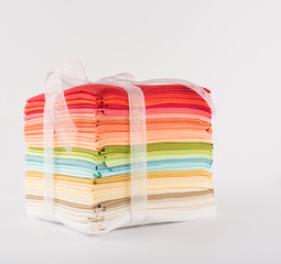 Fabric, fat quarter, pile of colorful cotton fabric isolated on white background, copy space