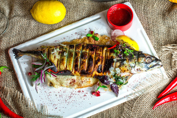 grilled mackerel steak with vegetables on plate