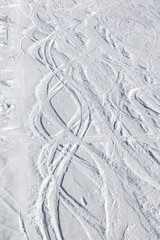Snowy ski slope with trace from skis and snowboards