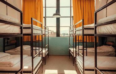 Bunk beds inside bedroom with big window and yellow curtains - obrazy, fototapety, plakaty