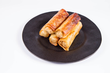 Chinese Traditional Spring rolls on a black plate