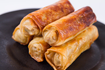 Chinese Traditional Spring rolls on a black plate