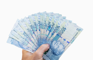 South African banknotes in hand.