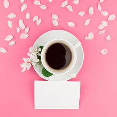 Obraz na płótnie Canvas Flat lay of coffee, letter mockup and white petals