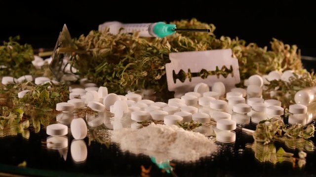 Cannabis, coke, razorblades, drugs, pills, XTC and needle rotating