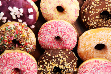 assorted donuts with chocolate frosted, pink glazed and sprinkles donuts