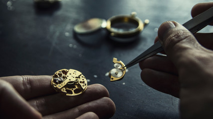 Watch maker is repairing a vintage automatic watch.