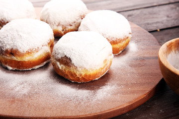 German donuts with jam and icing sugar. Carnival powdered sugar raised donuts
