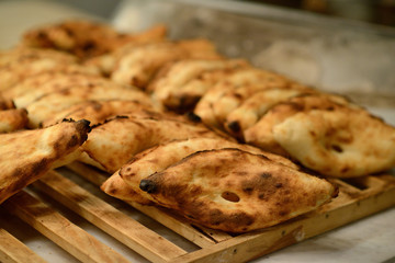 Georgian pita bread on a wooden grate