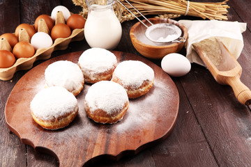 german donuts or berliner with ingredient on rustic background