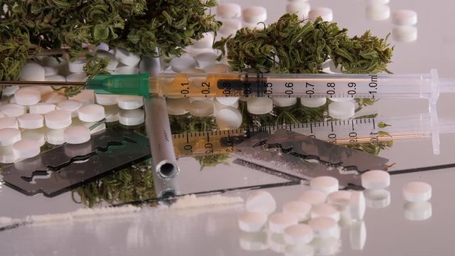 Cannabis, coke, razorblades, drugs, pills, XTC and needle rotating