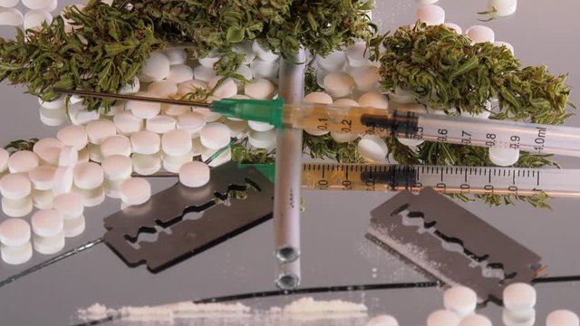 Cannabis, coke, razorblades, drugs, pills, XTC and needle rotating