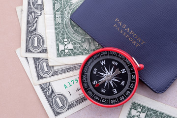 Passport with One Dollar paper currency and Compass