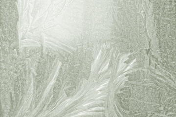 frosty pattern on the window draws winter light from the window