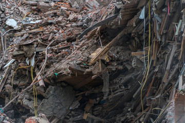 Fototapeta premium The wreckage and the skeleton of an old building destroyed to make room for modern development