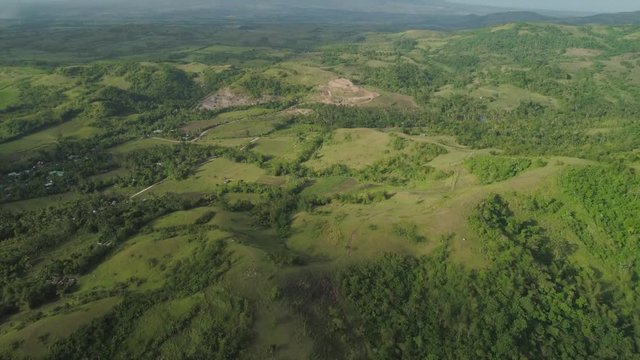 Aerial view of mountain valley with hillscovered forest, trees, mount Iriga. Luzon, Philippines. Slopes of mountains with evergreen vegetation. Mountainous tropical landscape.