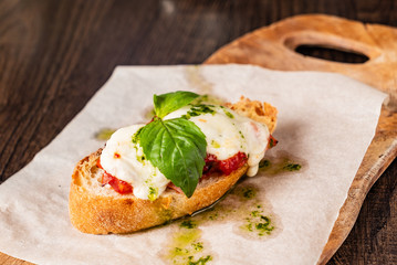 Traditional italian bruschetta with cherry tomatoes, cream cheese, basil leaves